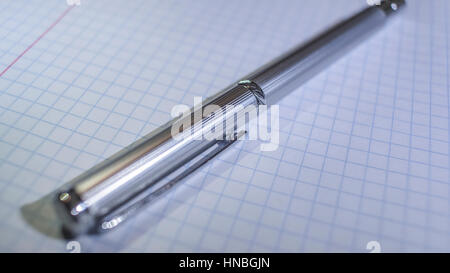 The shiny expensive metal pen on a notebook in the box Stock Photo