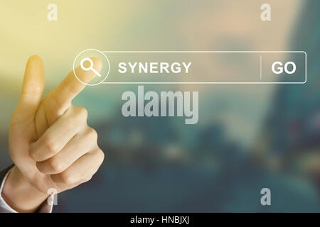 business hand clicking synergy button on search toolbar with vintage style effect Stock Photo
