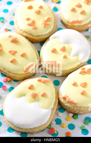 Easter frame. Easter eggs, various cookies and confectionery sugar sprinkling on a wooden table. Stock Photo