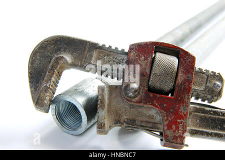 pipe wrench with water pipes on white background Stock Photo