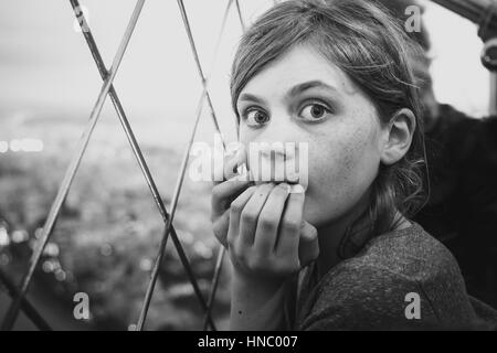 Scared Girl standing on Eiffel Tower, Paris, France Stock Photo