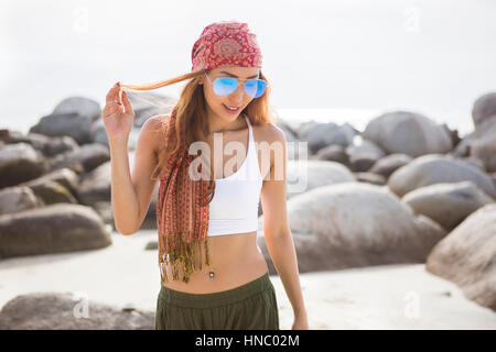 Portrait of a woman on beach playing with her hair Stock Photo
