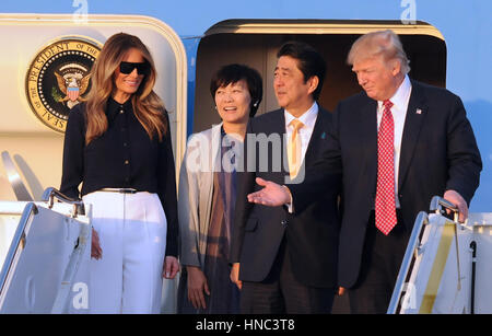 West Palm Beach, Florida, USA. 10th Feb, 2017. U.S. President Donald Trump (R) gestures after arriving on Air Force One at Palm Beach International Airport in Florida on February 10, 2017. Trump was accompanied by First Lady Melania Trump (L), and by Japanese Prime Minister Shinzo Abe and his wife, Akie Abe (center). President Trump invited the Japanese leader to spend the weekend at Trump's Mar-A-Lago estate in Palm Beach, Florida, dubbed the 'Winter White House', where they will hold meetings and play golf. Credit: Paul Hennessy/Alamy Live News Stock Photo