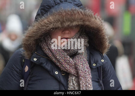 Wimbledon London, UK. 11th Feb, 2017. Pedestrians and shoppers in Wimbledon town centre brave the sleet and freezing conditions Credit: amer ghazzal/Alamy Live News Stock Photo