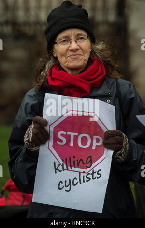 London, UK. 11th February 2017. Gathering in Trafalgar Square - Stop Killing Cyclists stage a die-in to remember Anita Szucs, 30 and Karla Roman, 32 (both killed while cycling on Monday), and Ben Wales, 32. They are demanding investment in cycling and walking in the hope that it rises to 10% of the UK transport budget by the end of this parliament. Credit: Guy Bell/Alamy Live News Stock Photo