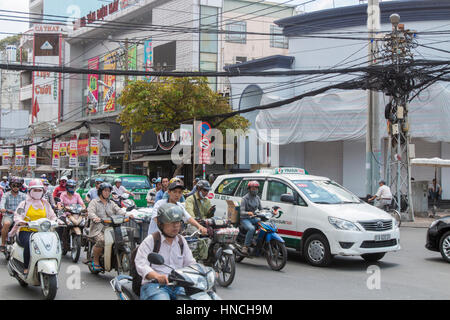 Scooter motorbike riders travelling through Ho Chi Minh city in Vietnam,Asia Stock Photo