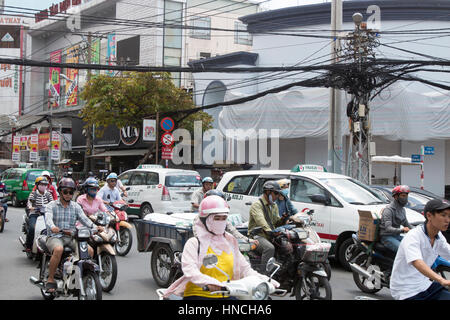 Scooter motorbike riders travelling through Ho Chi Minh city in Vietnam,Asia Stock Photo