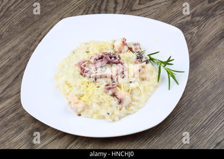 Risotto with octopus served green rosemary Stock Photo - Alamy