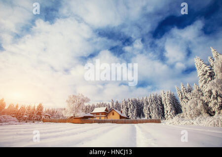 beautiful wooden house in a winter sunny day Stock Photo