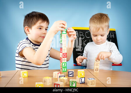 Children playing with cubes on the table Stock Photo