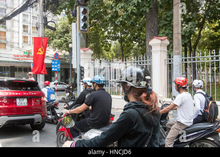 Scooter motorbike riders travelling through Ho Chi Minh city in Vietnam,Asia Stock Photo