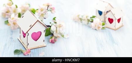 White Wood houses with colorful heart shaped windows. Stock Photo