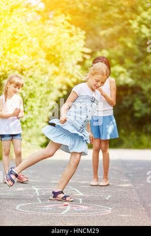 Children play hopscotch in summer in kindergarten Stock Photo
