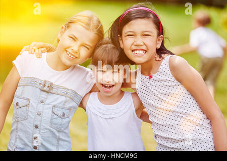 Happy group of girls in kindergarden in summer Stock Photo