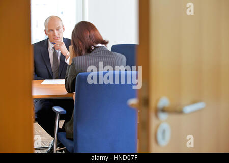 Businessman in discussion with businesswoman Stock Photo