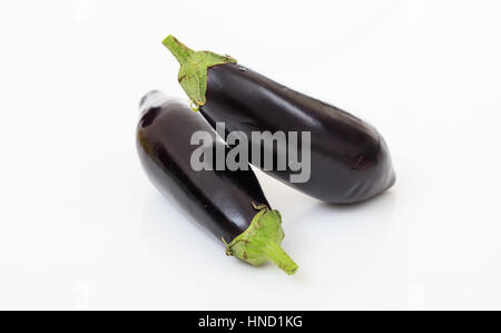 Two whole aubergines isolated on white background Stock Photo
