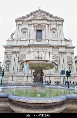 Rome, Italy - January 8, 2017: Sant'Andrea Della Valle Fountain and Basilica facade view in Rome. Unidentified people walking on the street. Stock Photo