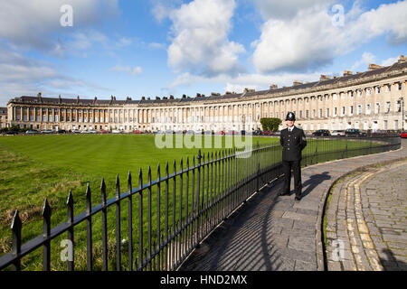 A policeman in uniform standing on the iconic Royal Crescent in bath, England Stock Photo