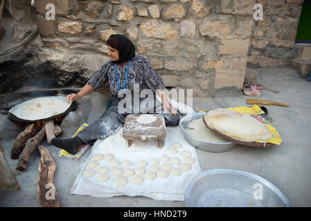 A kurdish woman preparing traditional bread, Palangan ancient village, Iranian Kurdistan, Iran Stock Photo