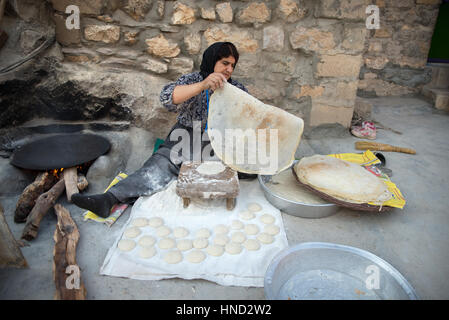 A kurdish woman preparing traditional bread, Palangan ancient village, Iranian Kurdistan, Iran Stock Photo