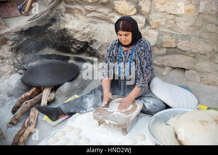 A kurdish woman preparing traditional bread, Palangan ancient village, Iranian Kurdistan, Iran Stock Photo