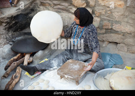 A kurdish woman preparing traditional bread, Palangan ancient village, Iranian Kurdistan, Iran Stock Photo