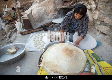 A kurdish woman preparing traditional bread, Palangan ancient village, Iranian Kurdistan, Iran Stock Photo