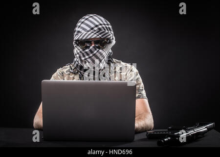 Terrorist working on his computer. Concept about international crisis, war and terrorism Stock Photo