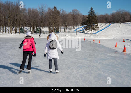 Montreal, CA - 31 January 2017: people skating on Beaver Lake skating rink on Mount-Royal Stock Photo