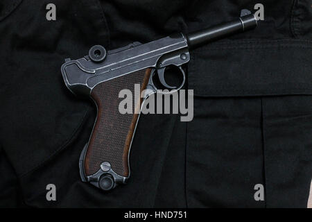 Revolver is black view left. Revolver on cloth. Stock Photo