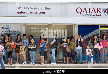 Tram stop, crowded, People waiting in Tramway stop.Des Voeux Road,Hong Kong, China Stock Photo