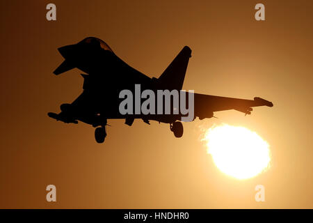 RAF Typhoon on approach to RAF Coningsby as it flies through the setting sun. Stock Photo