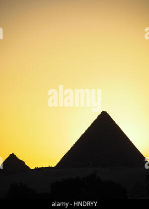 A silhouette of the great pyramids of Egypt in Giza outside of Cairo. Stock Photo