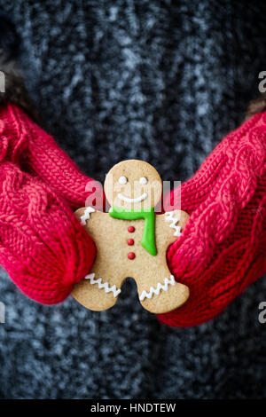 Rustic Note Paper Background Gingerbread man in female hands on dark rustic background with ...