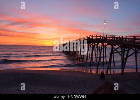 Sunrise over the pier in Kure Beach North Carolina Stock Photo