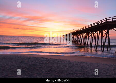 Sunrise over the pier in Kure Beach North Carolina Stock Photo