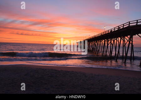 Sunrise over the pier in Kure Beach North Carolina Stock Photo