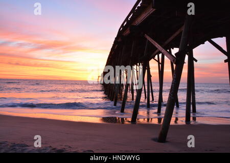 Sunrise over the pier in Kure Beach North Carolina Stock Photo