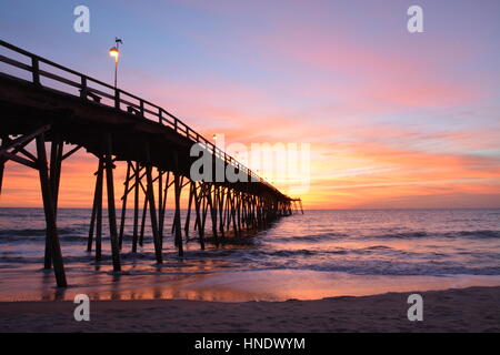 Sunrise over the pier in Kure Beach North Carolina Stock Photo