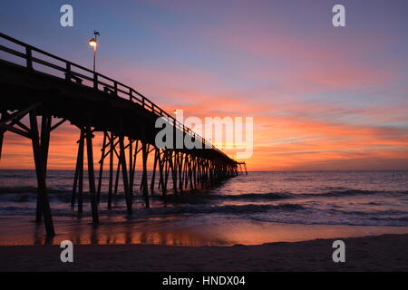 Sunrise over the pier in Kure Beach North Carolina Stock Photo