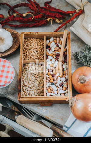 Beans, grains, vegetables and kitchen utensils on metal table Stock Photo