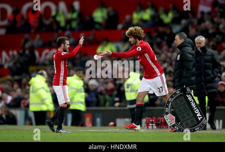 Manchester United's Marouane Fellaini (right) is substituted on for Manchester United's Juan Mata during the Premier League match at Old Trafford, Manchester.