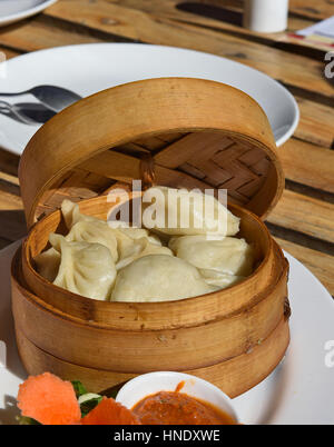 Chinese dumplings in served in wooden container Stock Photo