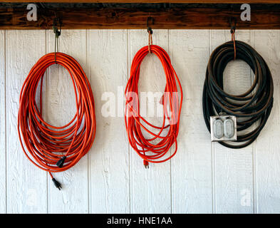 Extension power cords on the wall of working shop Stock Photo