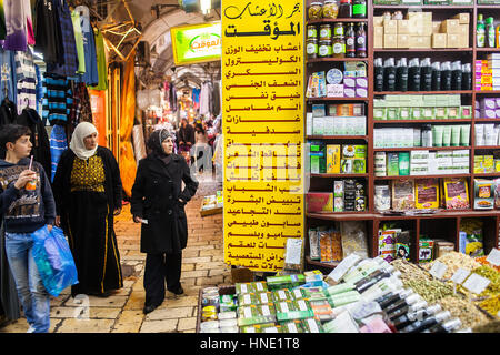 Woman, women, man, Shop of natural beauty products, souk Arabic market, Muslim Quarter,Old City, Jerusalem, Israel. Stock Photo