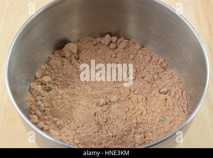 Close up of chocolate cake or brownie with chocolate chips in stainless steel mixing bowl Stock Photo