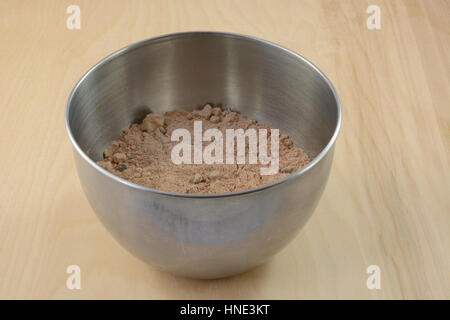 Chocolate cake or brownie with chocolate chips in stainless steel mixing bowl Stock Photo