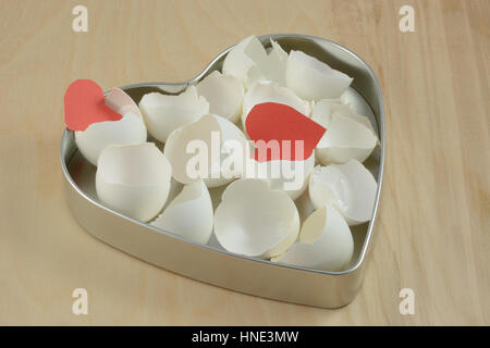 Eggs inside big heart hatching tiny baby red hearts Stock Photo