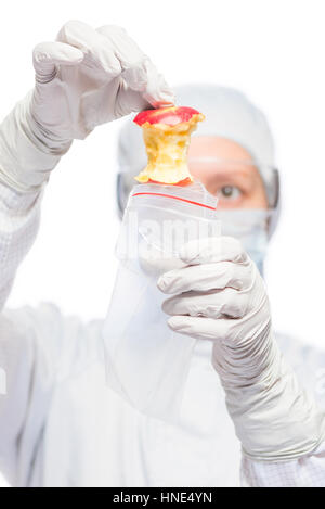 criminologist in a suit puts evidence in the bag from the crime scene Stock Photo
