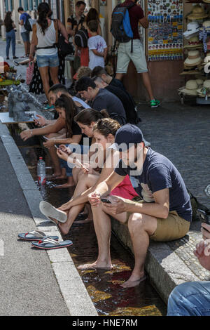 Cooling off in the Freiburg runnels, Freiburg im Breisgau, Germany Stock Photo